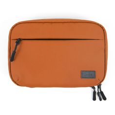 an orange toilet bag with black handles and zippers on the front, against a white background