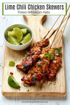 chicken skewers on a cutting board with dipping sauce