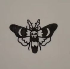 a black and white drawing of a bee with skull eyes on it's back