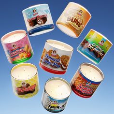 six candles are arranged in the shape of a circle on a blue background with an advertisement for cookies and buns