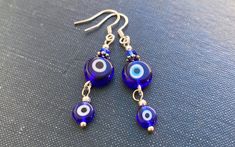 These are elegant earrings with Greek Evil Eye pendants. The hooks are stamped sterling silver (925). All parts are lead and nickel safe. The earrings will be sent in a lovely Red Cherry Gems gift box ready for gifting. If you have any questions, please do ask. The Greeks have used these blue Evil Eyes talismans to protect against the evil eye. The evil eye is a curse believed to be cast by a malevolent glare, usually given to a person when they are unaware. Many cultures believe that receiving Blue Round Evil Eye Earrings, Sterling Silver Dangle Evil Eye Jewelry, Sterling Silver Evil Eye Dangle Earrings, Silver Round Evil Eye Earrings, Blue Evil Eye Dangle Earrings, Blue Sterling Silver Evil Eye Earrings, Blue Evil Eye Dangle Jewelry, Greek Evil Eye, Evil Eyes