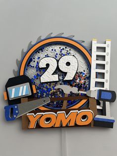 there is a clock made out of different things on the side of a building that says 29 yomo