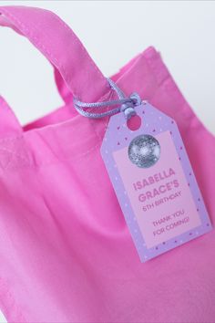 a pink tote bag with a tag on it that says, isbella grace's 6th birthday thank you for coming