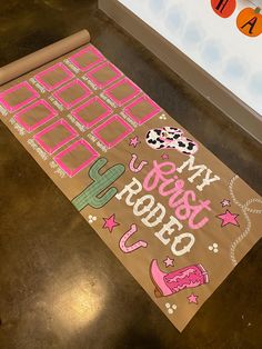 a brown paper bag with pink writing on it sitting on top of a wooden table