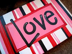 a painting with the word love painted on it in black, white and red stripes