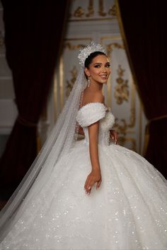 a woman in a wedding dress posing for the camera