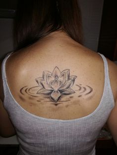 a woman with a lotus tattoo on her back