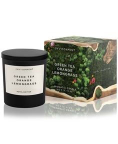 an orange and broccoli candle next to a box of green tea lemongrass