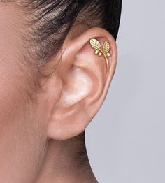 "This is a beautiful Boho chic cartilage earring, that will always attract attention! It is a single solid 14k gold helix earring in the shape of a stem with leaves and berries. It is held by a hole on the top of the ear and comes with a 14k gold ear backing. I have added the last picture with the location of the piercing in the ear colored in black that fits the earring. The length from the end of the stem to the end of the central leaf is 1 inch ( 2.5 cm) The maximum width is 0.4 inches (1 cm Ear Piercing Cartilage, Gold Helix Earrings, Gold Cartilage Earrings, Ear Cuff Gold, Woodland Jewelry, Piercing Cartilage, Gold Ear Cuff, Cartilage Earring, Helix Earrings