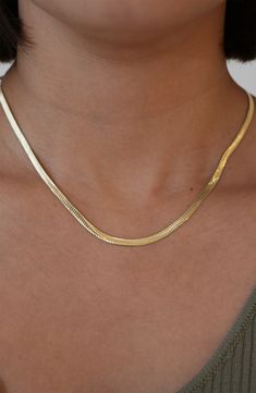 Simple and elegant on its own and stunning layered with other chains, this slender sterling silver or gold-plated necklace adds subtle shine to any neckline. 16 1/4" length; 2" extender; 1/8" band width Lobster clasp closure 18k-gold plate with sterling silver or sterling silver Made in Italy Formal Classic Snake Chain Necklace, Gold Snake Chain Choker For Everyday, Elegant Herringbone Chain Choker Necklace, Chic Gold Snake Chain Necklace For Everyday, Chic Everyday Gold Snake Chain Necklace, Classic Gold Snake Chain Necklace With Delicate Chain, Elegant Gold-plated Herringbone Necklace With Box Chain, Elegant Gold Plated Herringbone Necklace With Box Chain, Classic Gold Delicate Snake Chain Necklace