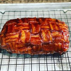 a piece of meat sitting on top of a cooling rack