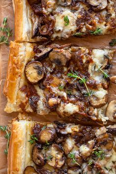 mushroom and cheese pizza sliced on top of parchment paper