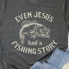 THE STORY "Celebrate Faith and Fishing with Our 'Even Jesus Had a Fishing Story' Shirt!" Combine your love for fishing and your faith with a shirt that highlights the timeless connection between the two. The "Even Jesus Had a Fishing Story" shirt is perfect for those who enjoy casting lines and sharing stories, all while celebrating their spiritual journey. THE FIT True-to-fit. If you prefer a looser fit, we recommend ordering one size larger than normal. SPECS "Printed on Bella Canvas short-sle Fishing Outfits For Women Summer, Green Font, Funny Fishing Shirts, Shirt Inspiration, Country Clothing, Fishing Humor, Fishing Outfits, Fishing T Shirts, Jesus Shirts