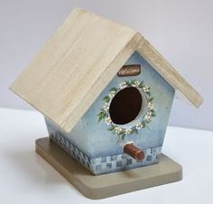 a blue birdhouse sitting on top of a white table