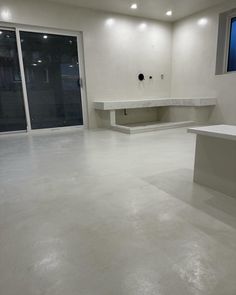 an empty room with white walls and flooring is pictured in this image, there are no people