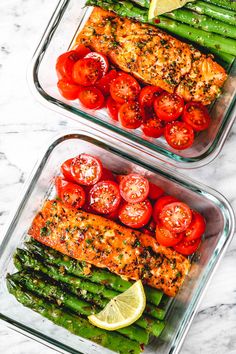 two glass dishes filled with salmon, asparagus and tomatoes on top of a marble counter