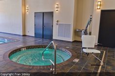 an indoor jacuzzi is shown in the middle of a room with tile flooring