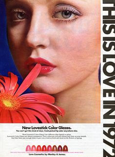 an advertisement for cosmetics with a woman holding a flower in her mouth