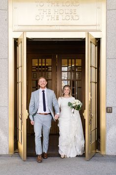 a bride and groom are walking out the doors to their wedding ceremony at city hall