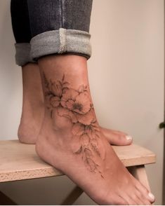 a close up of a person's foot with flowers on the bottom and side