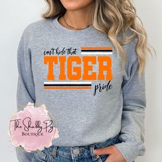 a woman wearing a sweatshirt that says, don't guide that tiger pride