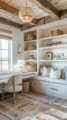 a room with white furniture and lots of shelves