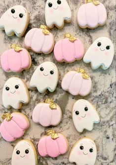 many decorated cookies are arranged on a table