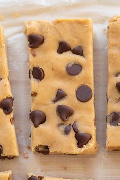 chocolate chip cookie bars cut into squares on a piece of parchment paper