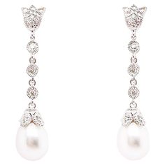 These stunning pearl earrings are the perfect wedding day look or for a formal outfit! The simple elegance of the diamonds and drop pearl scream the perfect wedding day accessory or dressy look! The details for these gorgeous earrings are listed below: 1 Set Metal Quality: 14K White Gold Earring Type: Drop Diamond Number: 10 Diamond Shape: Round Brilliant Diamond Total Weight: .14 ct Diamond Clarity: VS2 (excellent, eye clean) Diamond Color: G (excellent, near colorless) Diamond Shape: Round Brilliant Gemstone: Freshwater Pearl Gemstone Color: White w High Luster Gemstone Weight: 1.29 ct Measurements: 7 - 7.5 millimeters Post Type: Stud Total Carat Weight: 1.43 ct Wedding Dangle Earrings, Wedding Pearl Earrings, Vintage Diamond Earrings, Floral Design Wedding, Formal Earrings, Dangle Earrings Wedding, Pearl Earrings Wedding, Pearl And Diamond Earrings, Colorless Diamond