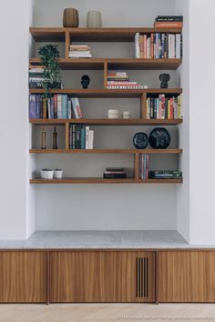 the bookshelf is made out of wood and has many different types of books on it