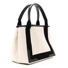 This is an authentic BALENCIAGA Cotton Canvas Satin Calfskin S Navy Cabas in Natural and Black. This impressive tote is crafted of a fine ivory canvas and black leather trim. This hand bag features black nylon accents that extend into top handles with leather grips and a BALENCIAGA logo. The top is open to a coarse black linen interior with a matching removable pouch. Linen Interior, Minimalist Accessories, Balenciaga Logo, Balenciaga Designer, Small Tote, Black Linen, Black Canvas, Black Logo, Black Nylons