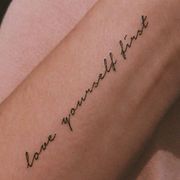 a woman's arm with the words love, happiness and trust written in cursive font