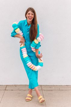 a woman in blue jumpsuits and yellow sandals holding an ice cream cone costume