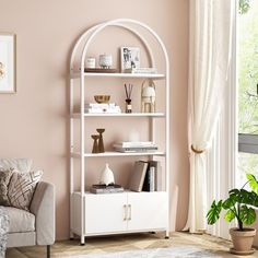 a living room with pink walls and white furniture