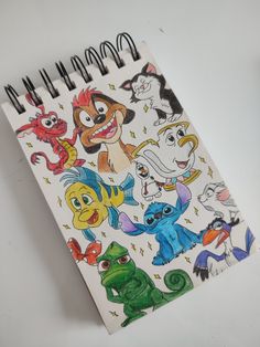 a spiral notebook with cartoon characters on it