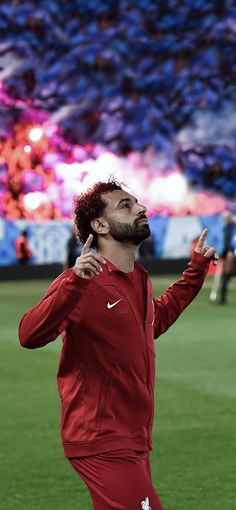 a man standing on top of a soccer field