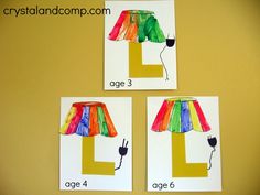 three different colored lamps made out of paper on a yellow wall with the letter l