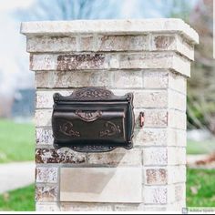 a mailbox mounted to the side of a brick wall