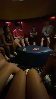 group of people sitting around a round table in a room