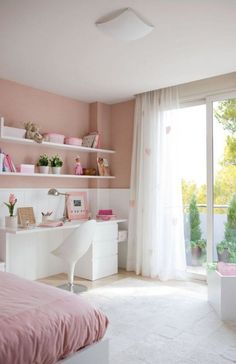 a bedroom with pink walls and white furniture