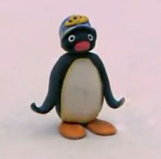 a toy penguin with a hat on its head