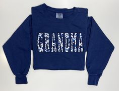 a blue sweatshirt with the word grandma printed on it