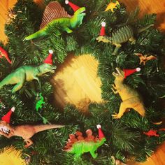 a christmas wreath with toy dinosaurs on it