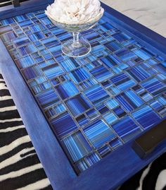 a blue tray with a flower on it and a zebra print area rug in the background