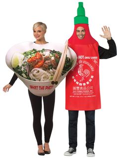 two people dressed in costumes standing next to each other and one holding a large bowl of food