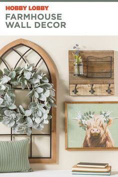 a living room with pictures on the wall and a wreath hanging from the wall above it