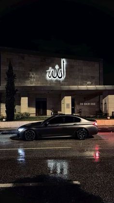 a car parked in front of a building at night with the word ald written on it