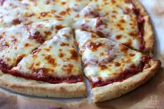 a pizza sitting on top of a pan covered in cheese