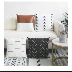 a white couch with black and white pillows on it