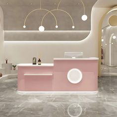 a pink counter in a store with lights hanging from the ceiling and round mirrors on the wall